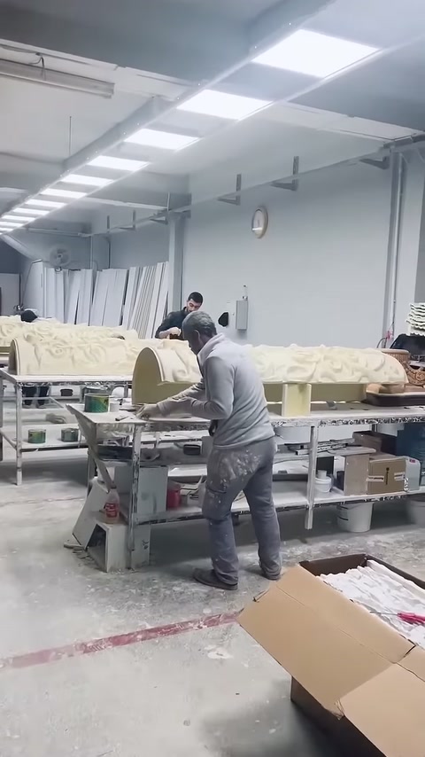 Ön tezgahtaki usta kemerli sütun tabanı parçasını düzeltiyor