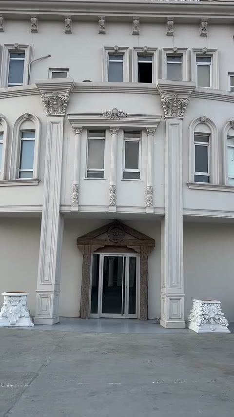 Klasik bina cephesinde dekoratif sütunlarla çevrelenmiş balkon bölümü bulunuyor