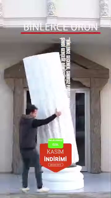 Büyük kare sütun gövdesi kaide üzerine yerleştirme aşamasında tutuluyor