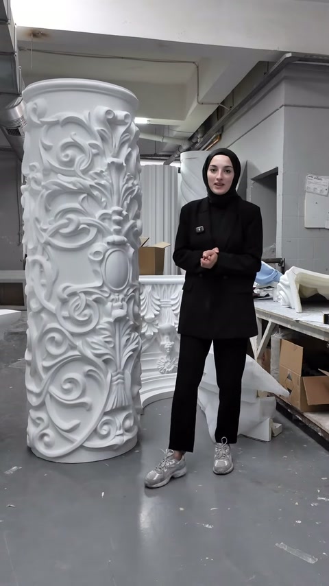 Atölyedeki yüksek bezemeli sütun gövdesinin kıvrımlı yüzeyi önden görülüyor.
