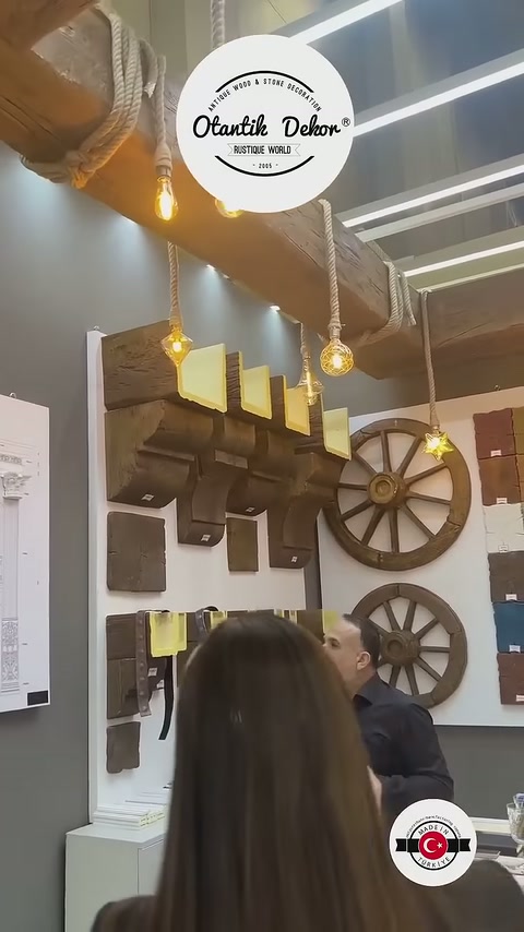 Görevli duvar standındaki farklı kiriş parçalarını eliyle işaret ediyor