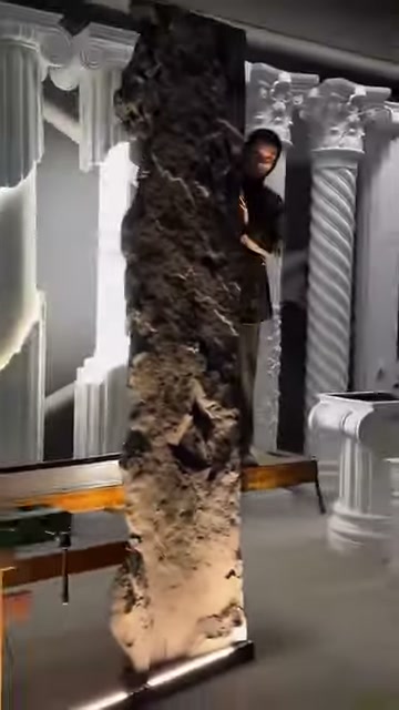 Doğal taş desenli panel, sütun örnekleri önünde inceleniyor