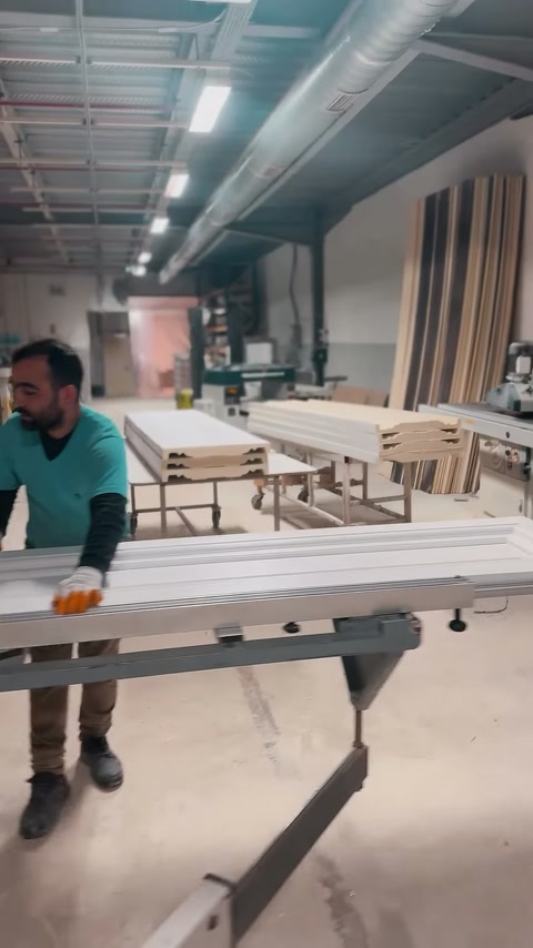 Çalışan uzun saçak profillerini metal çalışma masasında hizalıyor