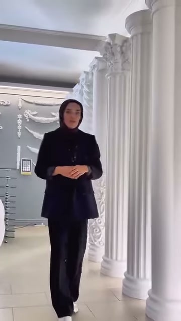 Tanıtıcı, uzun sütunların bulunduğu geçitte ürün çeşitlerini anlatıyor.